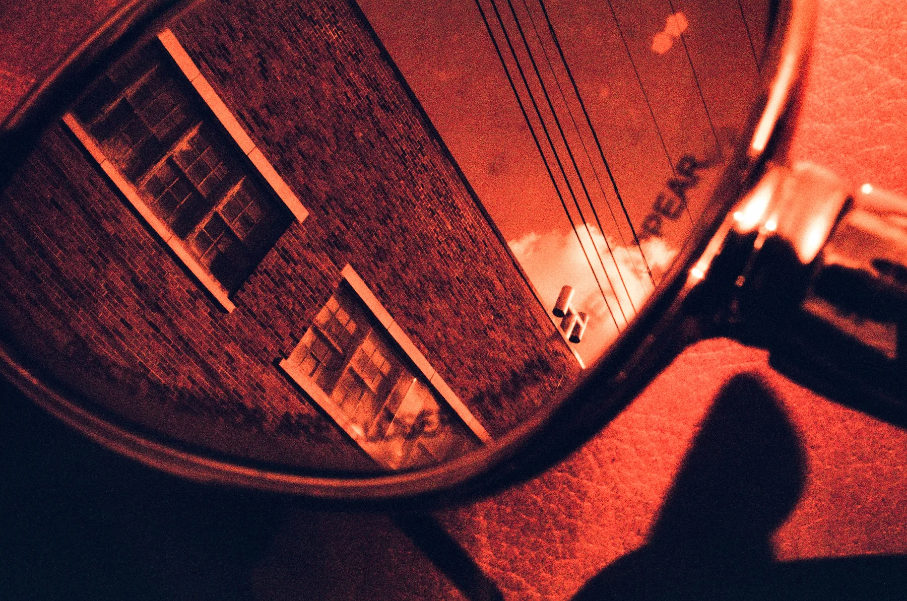 An angled reflection of a brick building and a shadow