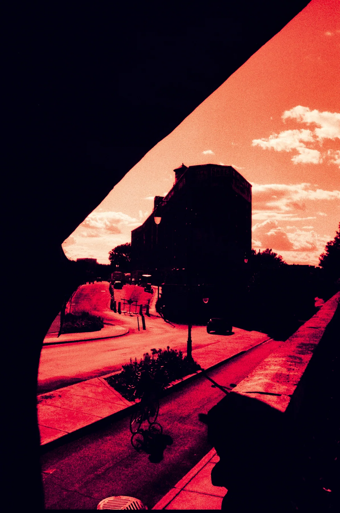 A street and distant building framed by an overpass