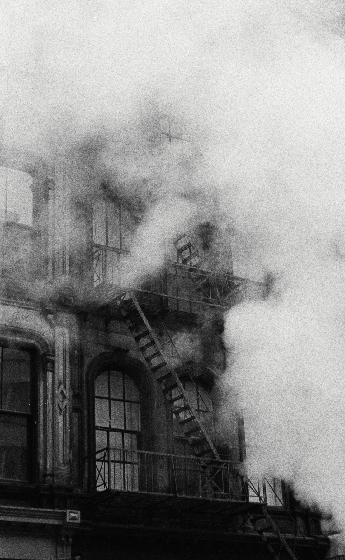 A building facade partly obscured by a cloud of steam