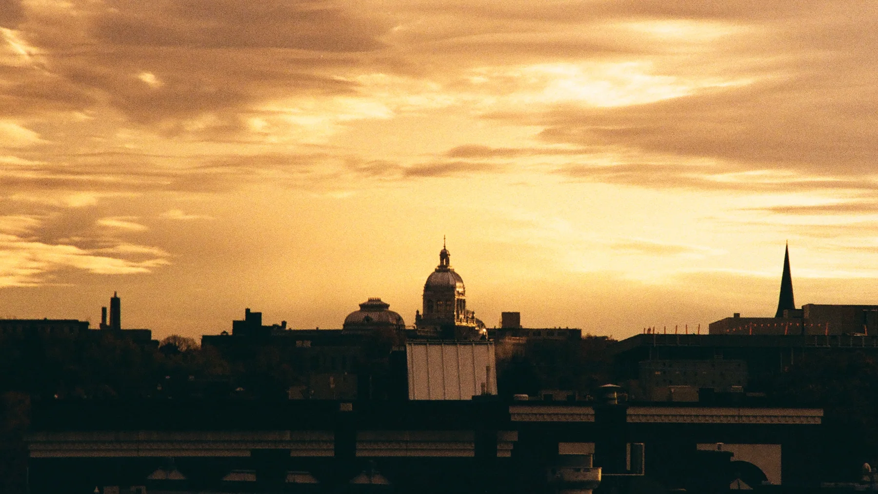 A city skyline beneath layered gold clouds