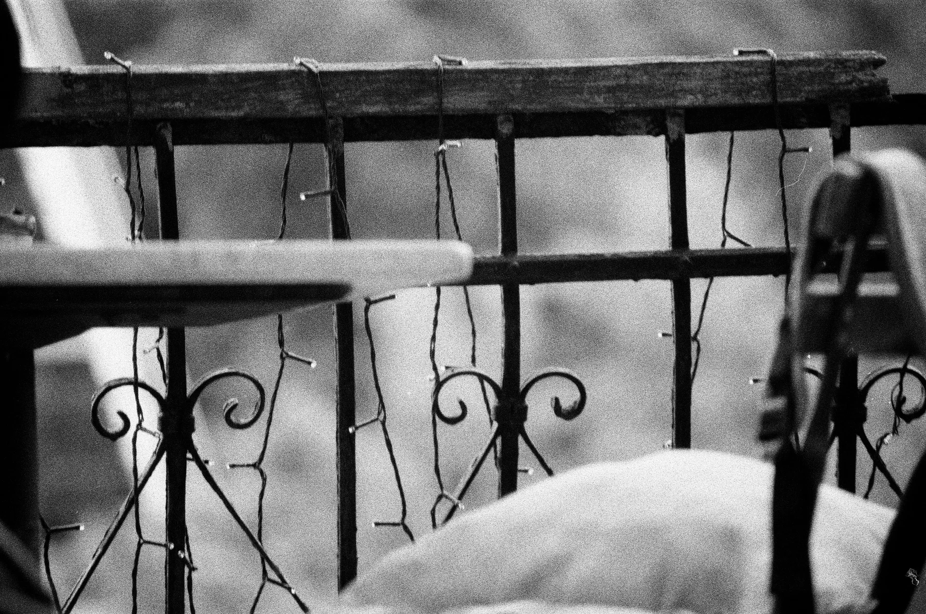 A snow-covered balcony railing in black and white