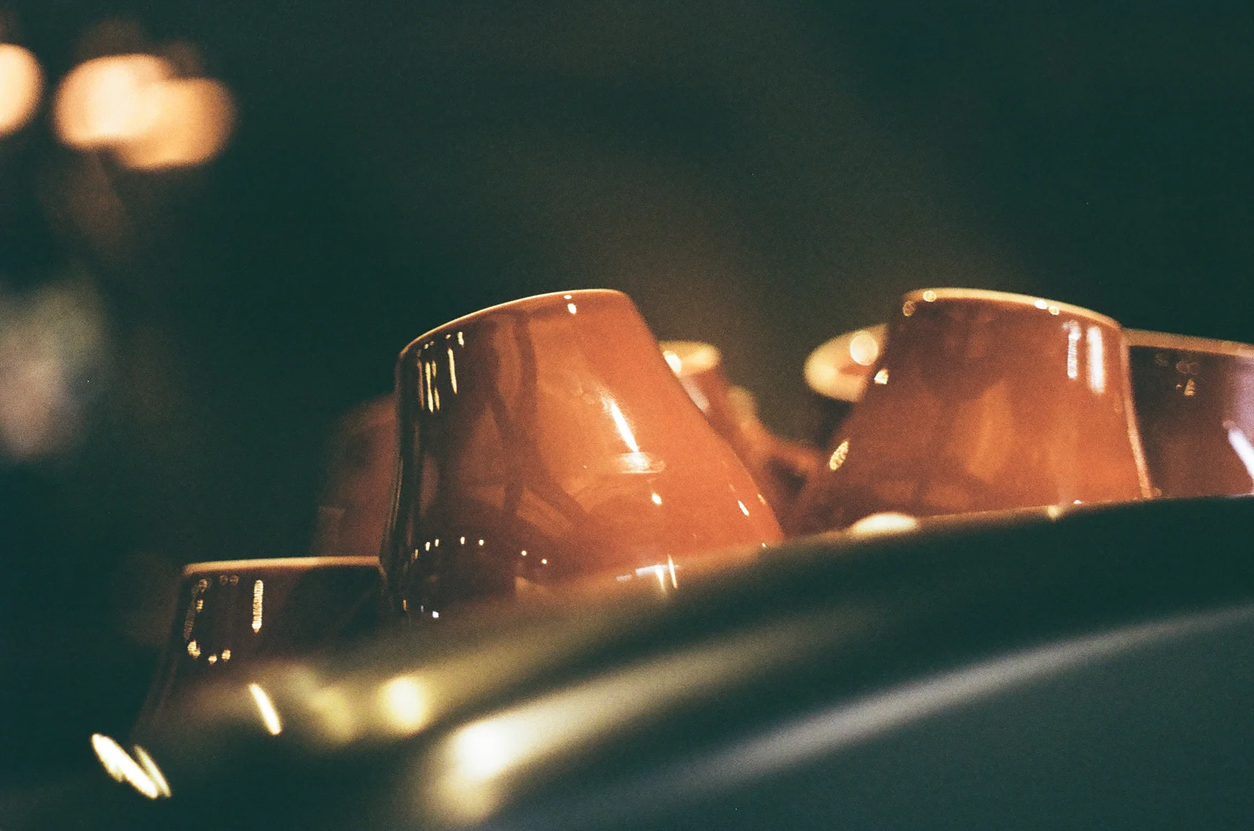 A row of amber cups catching light at night