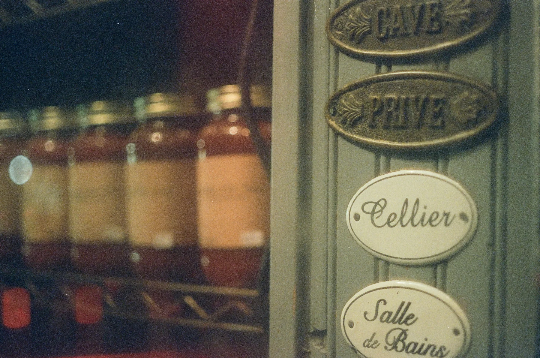 Layered hand-painted signs viewed through a window