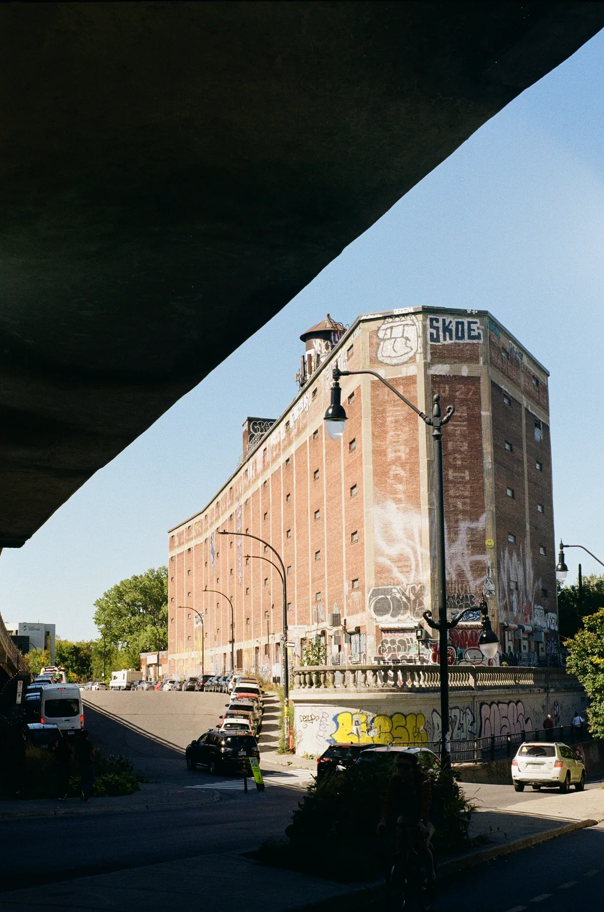 A weathered brick industrial building seen from below