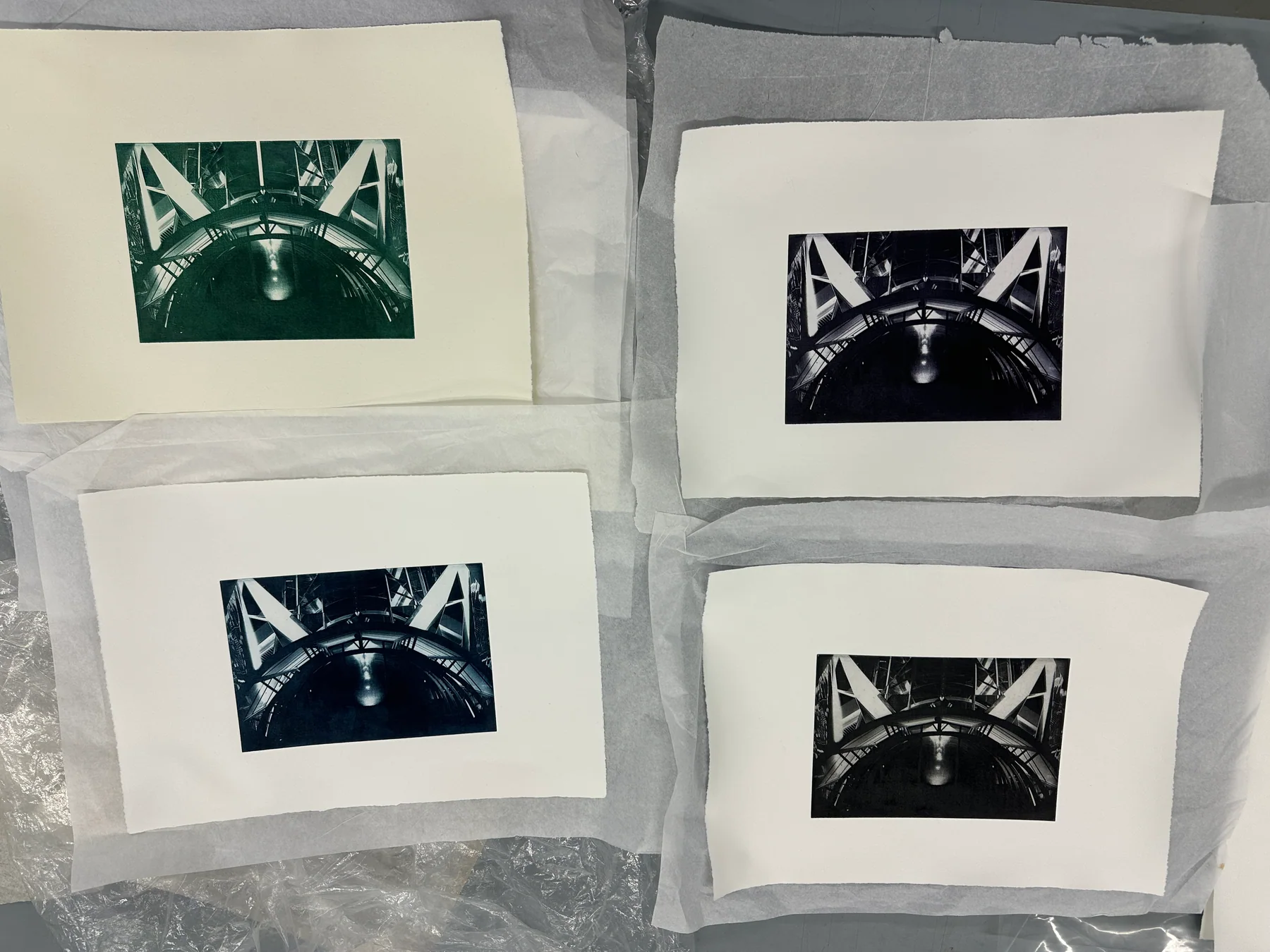 Four bridge photogravures laid out together in different colours